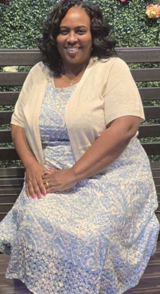 Stylish woman in orange outfit enjoying ice cream at a charming outdoor cafe, exuding summer vibes.